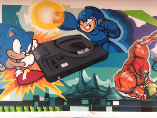 Smaller view of the painted mural of the history of gaming that wraps around the San Francisco headquarters of Skillz